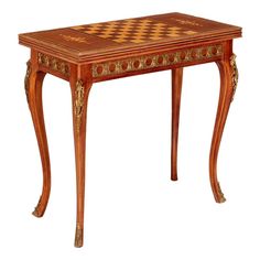 a small wooden table with a checkerboard design on it's top and legs