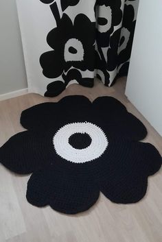 a black and white flower rug on the floor