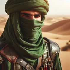 a man wearing a green turban in the desert