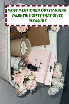 the contents of a valentine's gift sitting on top of a bed with flowers