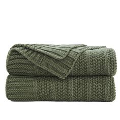 two green blankets folded on top of each other