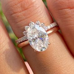 a woman's hand with a ring on it and a diamond in the middle