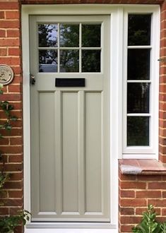 a white front door on a brick house