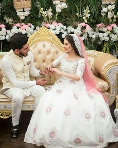 a bride and groom sitting on a couch