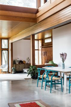 a dining room with blue chairs and a white table