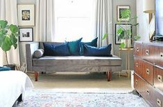 a living room filled with furniture and a flat screen tv on top of a wooden dresser