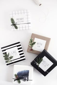 three boxes with christmas cards on them sitting next to each other in front of a white background