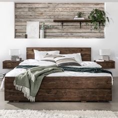 a large bed sitting in a bedroom next to a wooden wall