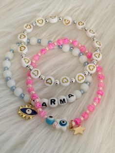 🌟 Set of 3 Karma & Evil Eye Bracelets 🌟 Embrace positivity and style with this exquisite set of 3 bracelets! Each unique design features meaningful charms and vibrant colors, perfect for adding a touch of luck to your accessory collection. Bracelet 1: Crafted with white beads accented by blue pearl beads, featuring a striking blue evil eye charm and the word "Karma" spelled out in beads, promoting good energy and protection. Bracelet 2: Made with silver beads adorned with flatback heart charms Pink Beaded Bracelets With Evil Eye, Pink Evil Eye Bracelets With Round Beads, Evil Eye Pink Bracelet, Baby Pink Evil Eye Bracelet, Pink Spiritual Jewelry With Evil Eye, Pink Eyes, Blue Evil Eye, Blue Pearl, Pink Marble