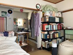 a bedroom with bookshelves and various items on the shelves