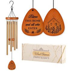 a wooden wind chime with an engraved plaque and box next to it that says, bless this home and all who enter