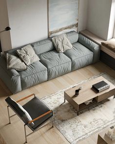 an overhead view of a living room with a couch and coffee table in the middle