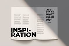 an open book with black and white typograms on the pages that read, inspire