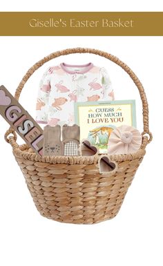 a basket filled with baby's clothing and toys, including a sign that says gisel's easter basket