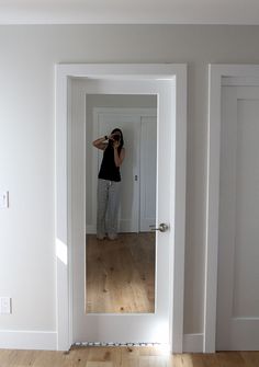 a woman taking a selfie in an empty room