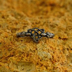 a silver ring sitting on top of a rock