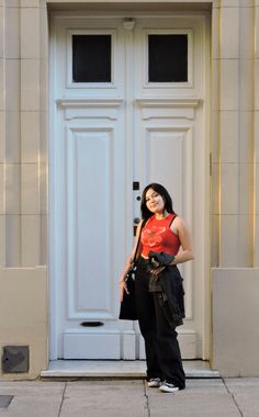 a woman standing in front of a white door