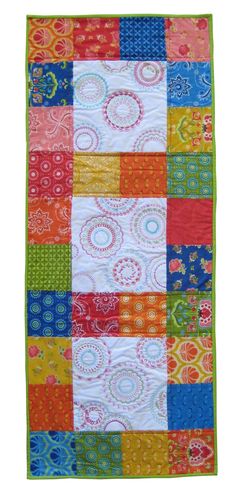 a multicolored patchwork quilt on a white background