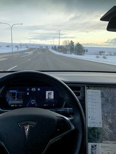 the dashboard of a car on a snowy road