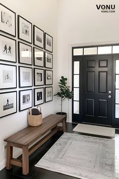 Entryway featuring a black front door, wooden bench with a basket, black and white framed photo gallery wall, and a cozy rug. French Country Entryway Ideas, Neutral Entryway, Tricorn Black, Wall Layout, Aesthetic Interior Design, Entry Ideas, Hallway Inspiration, Staircase Wall, Front Entryway