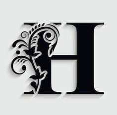 the letter h is made up of black and white paper with floral designs on it