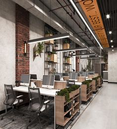 an office with many desks and chairs in front of a brick wall that has plants growing on it