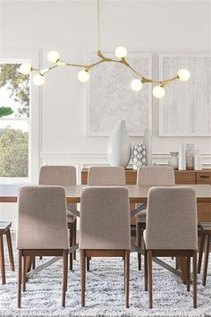 a dining room table with six chairs and a rug