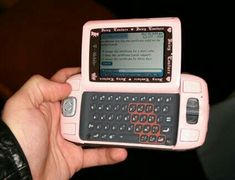 a person holding a pink and black cellphone in their hand with the screen turned on