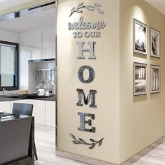 the welcome sign to our home is displayed in front of an open kitchen area with dining table and chairs