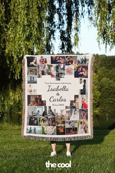 a woman standing in front of a tree holding up a blanket with photos on it