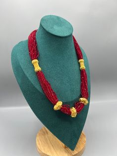 Introducing the exquisite "Nepalese Katar Gedi Hydro Potey Necklace" - a masterpiece inspired by the rich cultural heritage of Nepal. Handcrafted with love and skill by talented artisans, this necklace embodies the essence of Nepalese craftsmanship. Our company offers expedited Next-Day Delivery Services within the United Kingdom, ensuring prompt and efficient transportation of goods.  Additionally, we strive to extend our shipping capabilities to cater to customers worldwide, aiming to provide Nepali Jewelry Gold, Red Beads Necklace, Green Beads Necklace, Nepalese Jewelry, Nepali Jewelry, Red Beaded Necklaces, Green Beads, Red Bead, Cultural Heritage