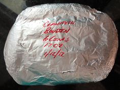 a piece of tin foil with writing on it that is covered in aluminum foil and sitting on a table