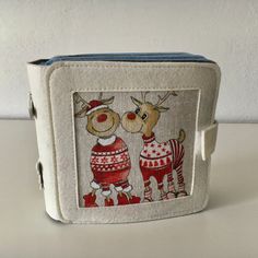 a small purse with two reindeers on it