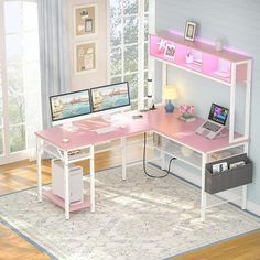 a computer desk with two monitors and a laptop on it in front of a window