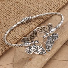 Accented with a large pair of butterflies, Yuli's gleaming silver cuff is positively striking. Artisans in Bali use sterling silver to hand craft the cuff, skillfully engraving the precious metal with ornate designs in a combination finish. Breslate Design For Girl, Silver Bracelet For Women Indian, Metal Bracelet Ideas, Silver Bangle Bracelet With Intricate Design, Antique Silver Bracelet With Intricate Design, Silver Cuff Bracelet With Intricate Design, Silver Bangle Bracelets Unique, Silver Hand Jewelry, Silver Kada Women