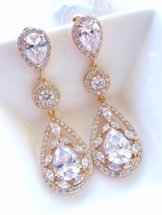 This earring features a large yellow gold plated fancy peardrop cubic zirconia dangle from a yellow gold plated halo round cubic zirconia and LARGE pear shaped cubic zirconia post earrings. Size: Approximately 5.8 cm or 2.6 inches long. It is light weight on the ears and white gold and rose gold plated is also available, just choose the colour you prefer from the colour option. Note: The pear shaped post stud earring used in this design is sightly larger than my other design which has the similar post earrings. If it is a larger pear shaped post stud used, I will mentioned it as large in the listing and the title. Matching necklace is also available. Earrings Large, Large Earrings, Matching Necklaces, Stud Earring, Bridal Earrings, Pear Shaped, Rose Gold Plates, Post Earrings, Or Rose