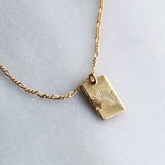 Our sun ray rectangle pendant necklace is a daily reminder to shine bright! Wear it alone or layer, it makes a great gift too! •Thick 19mm rectangle.•Choose your chain style.•100% 14kt Gold-Filled or Sterling Silver.•Stamped by hand with a sun ray Model is wearing 18 inch in photos & layered with our Unity Necklace Water friendly Rectangle Gold Necklace, Necklace Pendant Design, Minimal Gold Jewelry, Small Gold Necklace, Rectangle Pendant Necklace, Rectangle Necklace, Preppy Jewelry, Sun Necklace, Rectangle Pendant