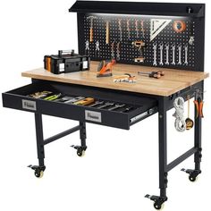 a workbench with many tools on the top and drawer open to show it's contents