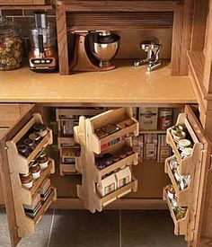 an open cabinet in the middle of a kitchen