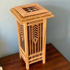 a small wooden stand on a table next to a wall