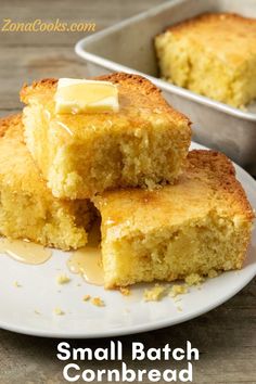 two pieces of cornbread on a plate with butter