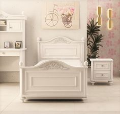 a bedroom with white furniture and pink flowers on the wall