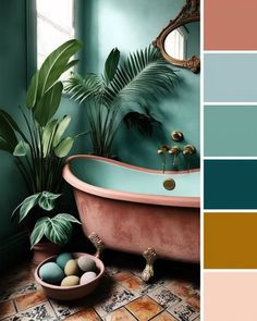 a bathroom with green walls, pink tub and gold fixtures in the center is a potted plant