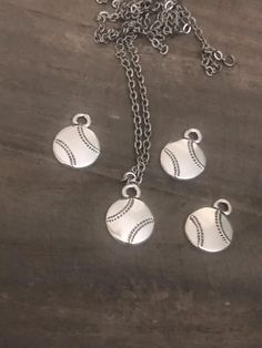 Quantity:  4 Pieces Chain not included  Description Batter's Up! Show your team spirit for the hitters, pitchers, and fielders in your life with this "striking" baseball charm. Combine with team colors or jersey numbers for personalized charm bracelets or necklaces. Product Details Part Number: 94-2460-12 Width (mm): 12.8 mm Height (mm): 17.1 mm Loop Inner Diameter (mm): 2.5 mm Materials and Finish: Cadmium & Lead free Pewter, Fine Silver plate with antiqued finish Country of Origin: USA TierraCast is known for their high quality, lead free pewter products. Diy Keyring, Jersey Numbers, Fan Jewelry, Baseball Fan, Sports Baseball, Antique Finish, Jewelry Diy, Team Spirit, Charm Bracelets