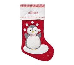 a christmas stocking with a penguin wearing a bow tie and name on the front