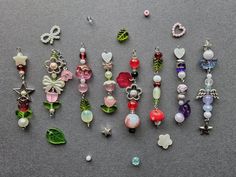 a collection of assorted necklaces sitting on top of a gray surface next to each other