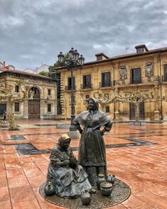 a statue of a woman sitting next to a child