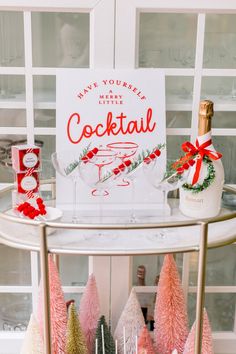 there is a sign that says have yourself merry cocktail on the side of a bar cart