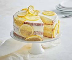 a cake with lemons on it sitting on a plate