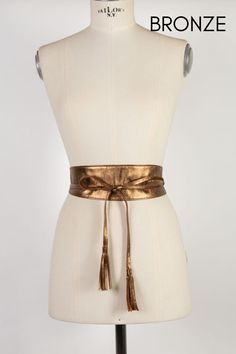 Stylish Obi leather belt handmade in our atelier with high-quality soft metallic leather in bronze color. Perfect to empower your look when you have to go to a wedding or special event. This glamorous obi belt has two small tassels at the end of the ties. It combines with blouses, pants, tunics, skirts, jeans, long baggy shirts, and all kinds of dresses.  Available in three sizes and also in other metallic leather colors. See color options. ##MEASURES: Width in all sizes (Widest part): 3 inches/ Chic Leather Corset Belt For Party, Chic Gold Belt For Party, Brown Leather Belts For Party, Brown Leather Belt For Party, Leather Party Belts, Brown Leather Party Belts, Chic Brown Party Belt, Elegant Gold Corset Belt For Parties, Chic Brown Belt For Party